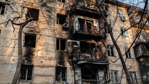 epa11084433 A woman cleans the debris from a damaged apartment block at the site of a Russian drone ...