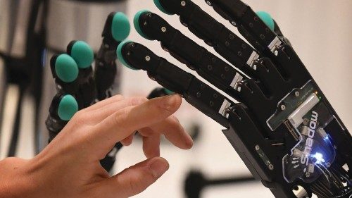 A woman touches a robotic hand produced by the Syntouch company during the Amazon Re:MARS conference ... A woman touches a robotic hand produced by the Syntouch company during the Amazon Re:MARS conference ...