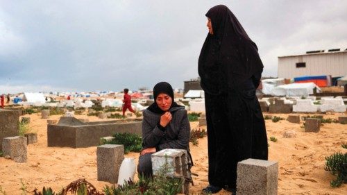 A woman cries over the grave of a loved one at the start of the Eid al-Fitr festival, marking the ... A woman cries over the grave of a loved one at the start of the Eid al-Fitr festival, marking the ...