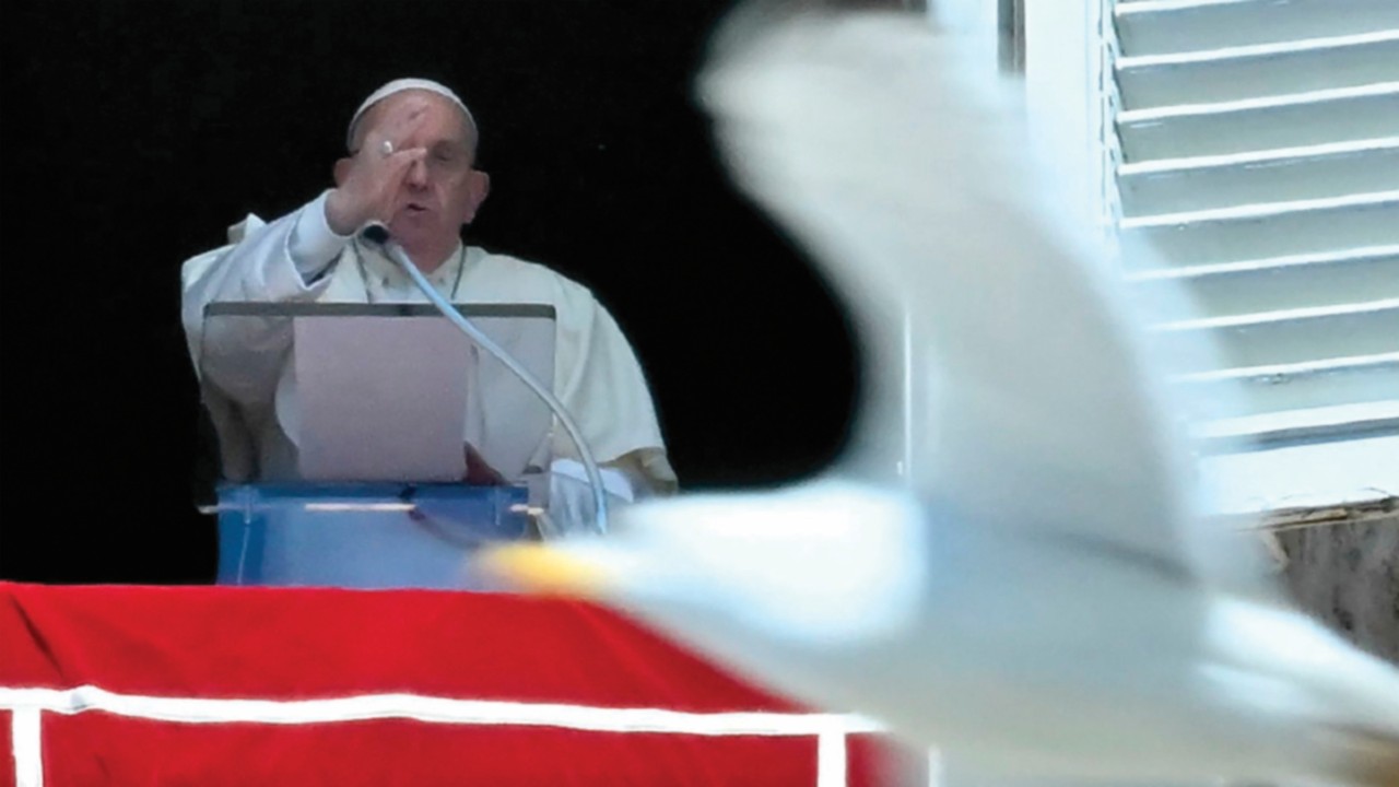 A gull flies in front of Pope Francis as he delivers his blessing to pilgrims during his Regina ...