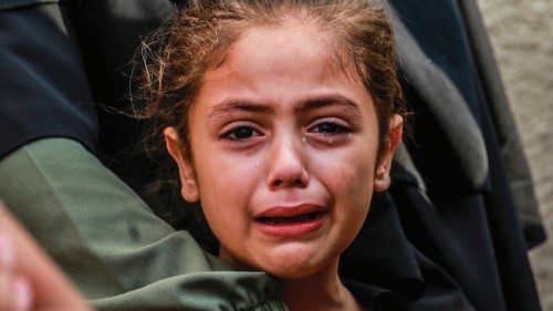 EDITORS NOTE: Graphic content / TOPSHOT - A girl cries as she and her relatives mourn the death of ... EDITORS NOTE: Graphic content / TOPSHOT - A girl cries as she and her relatives mourn the death of ...