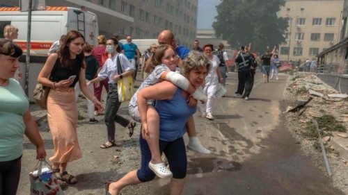 TOPSHOT - A woman carries a girl next to a heavily damaged building of the Ohmatdyt Children's ... TOPSHOT - A woman carries a girl next to a heavily damaged building of the Ohmatdyt Children's ...
