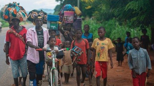 TOPSHOT - Displaced people from the province of Cabo Delgado walk through the streets of Namapa, ... TOPSHOT - Displaced people from the province of Cabo Delgado walk through the streets of Namapa, ...