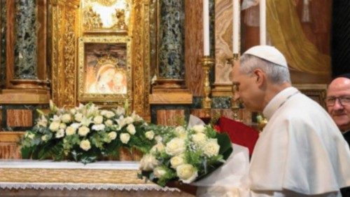 Pope Leo XIV brings flowers to set under a Marian fresco in the Shrine of Our Lady of Good Counsel ...